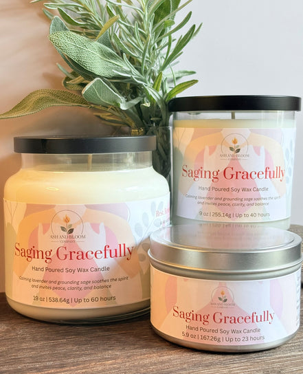 Three lavender and sage labeled 'Saging Gracefully' on a wooden surface with a plant in the background.