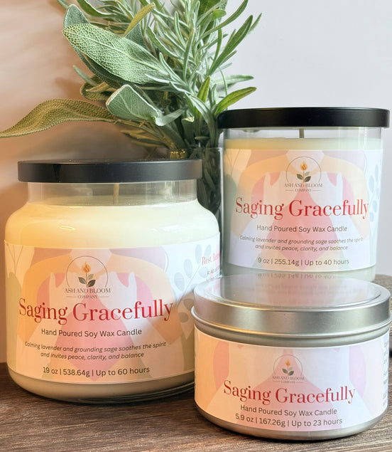 Three lavender and sage labeled 'Saging Gracefully' on a wooden surface with a plant in the background.