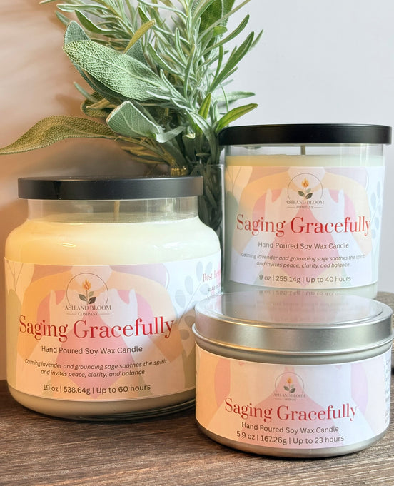 Three lavender and sage labeled 'Saging Gracefully' on a wooden surface with a plant in the background.