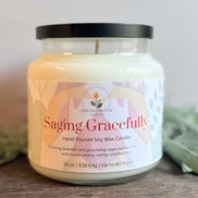 Lavender and Sage Candle jar labeled 'Saging Gracefully' with a plant in the background