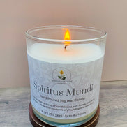 Nag champa candle labeled 'Spiritus Mundi' with a wooden coaster on a light wood surface.