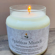 Nag champa candle in a glass jar labeled 'Spiritus Mundi' by Ashland Bloom on a wooden surface.