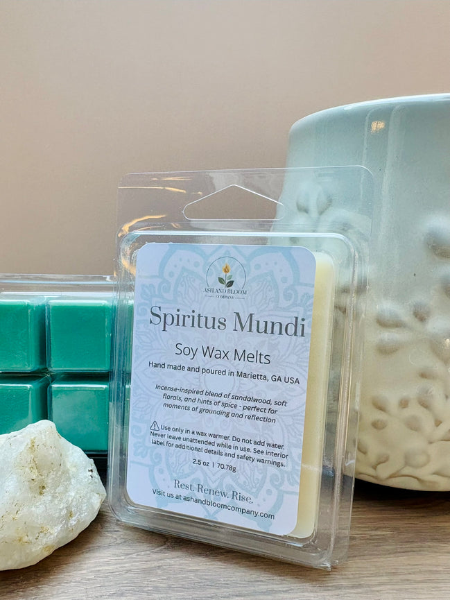 Nag Champa scented soy wax melts packaging with a candle and teal wax cubes on a wooden surface