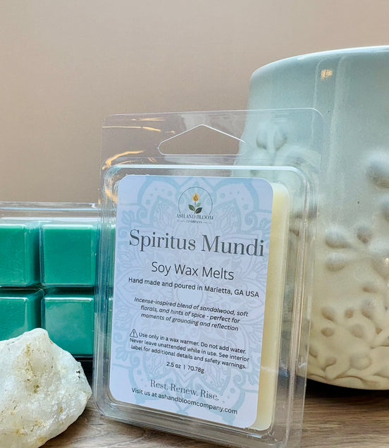 Nag Champa scented soy wax melts packaging with a candle and teal wax cubes on a wooden surface