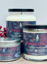Three cranberry and apple 'Holiday Hearth' candles with red berries on a light background
