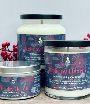 Three cranberry and apple 'Holiday Hearth' candles with red berries on a light background
