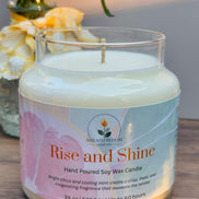 Citrus and mint candle with 'Rise and Shine' label on a wooden surface