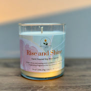 Citrus and mint candle labeled 'Rise and Shine' on a wooden surface with a neutral background