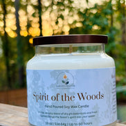 Candle labeled 'Spirit of the Woods' on a wooden surface with a blurred natural background