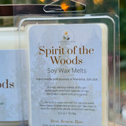 Soy gin and cypress wax melts packaging labeled 'Spirit of the Woods' with a blurred outdoor background.