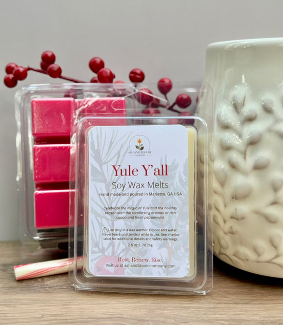 Peppermint and hot chocolate Yule Yall soy wax melts packaging with a candle and berries on a wooden surface