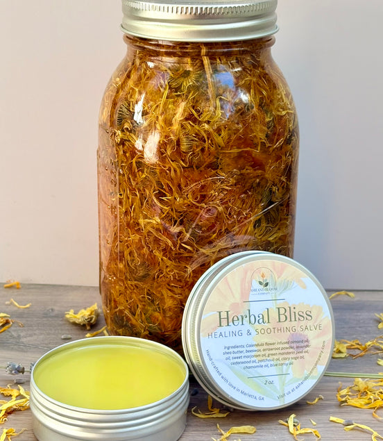 Jar of dried calendula flowers with a salve container labeled 'Herbal Bliss' on a wooden surface.