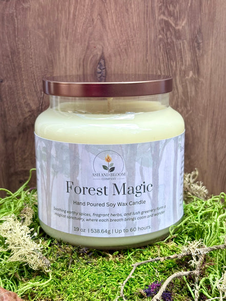 Candle jar labeled 'Forest Magic' on a wooden surface with grass.