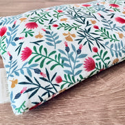 Folded fabric with floral pattern on a wooden surface