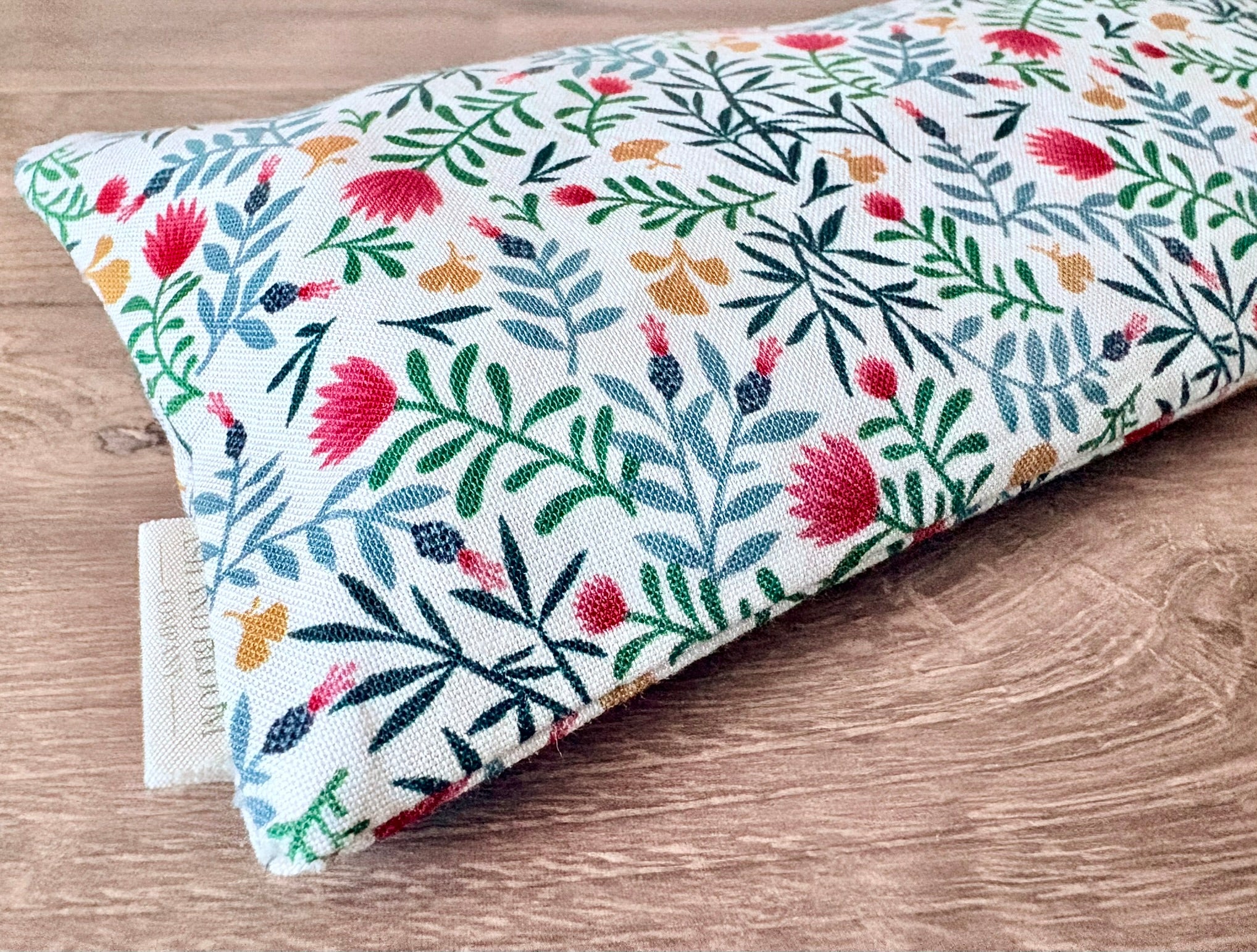 Folded fabric with floral pattern on a wooden surface