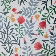 Patterned fabric with red, green, and yellow flowers on a white background