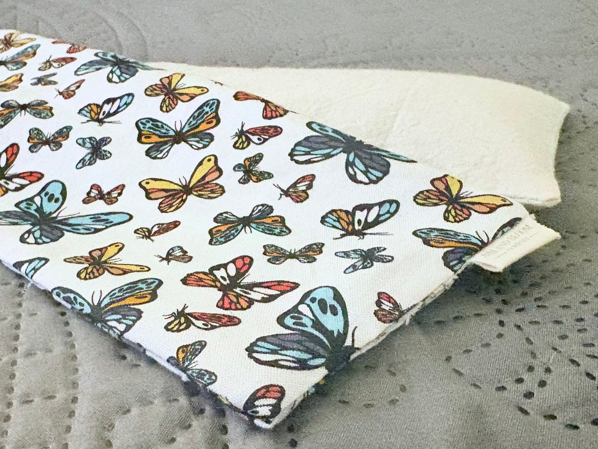 Fabric with butterfly pattern on a gray surface