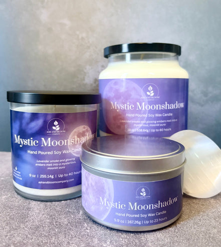 Three 'Mystic Moonshadow' candles of different sizes on a neutral background