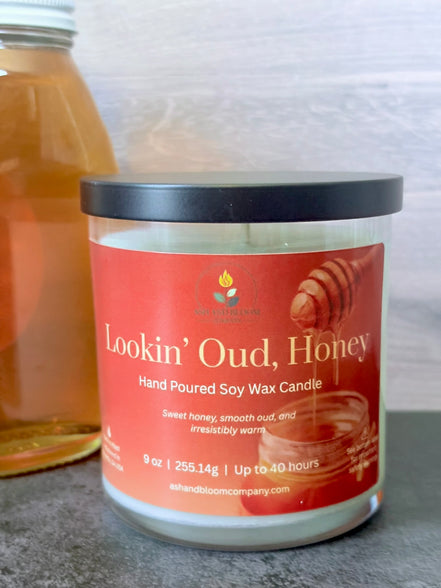 Hand poured soy wax candle labeled 'Lookin' Oud, Honey' on a neutral background