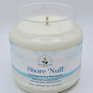 Candle in a glass jar with 'Shore 'Nuff' branding on a light gray background