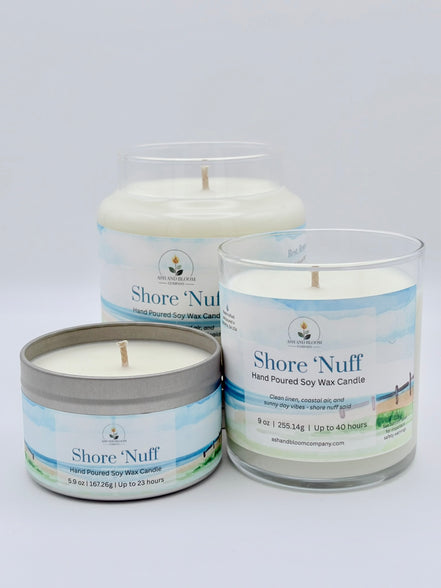 Three 'Shore 'Nuff' candles in different packaging on a white background